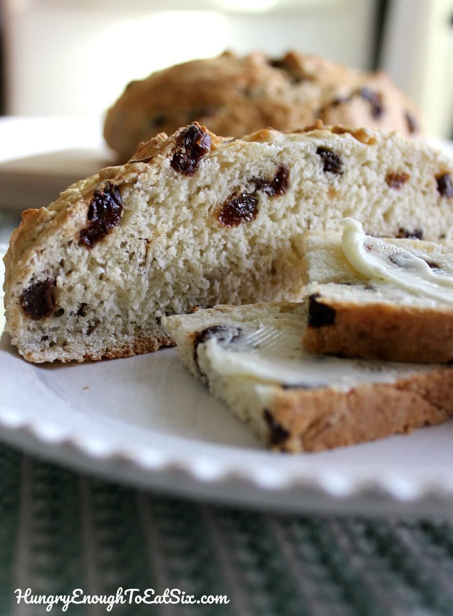 Image of Aunt Lizzie's Irish Soda Bread sliced and spread with butter.