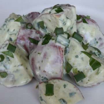 Potato salad with creamy dressing and diced scallions