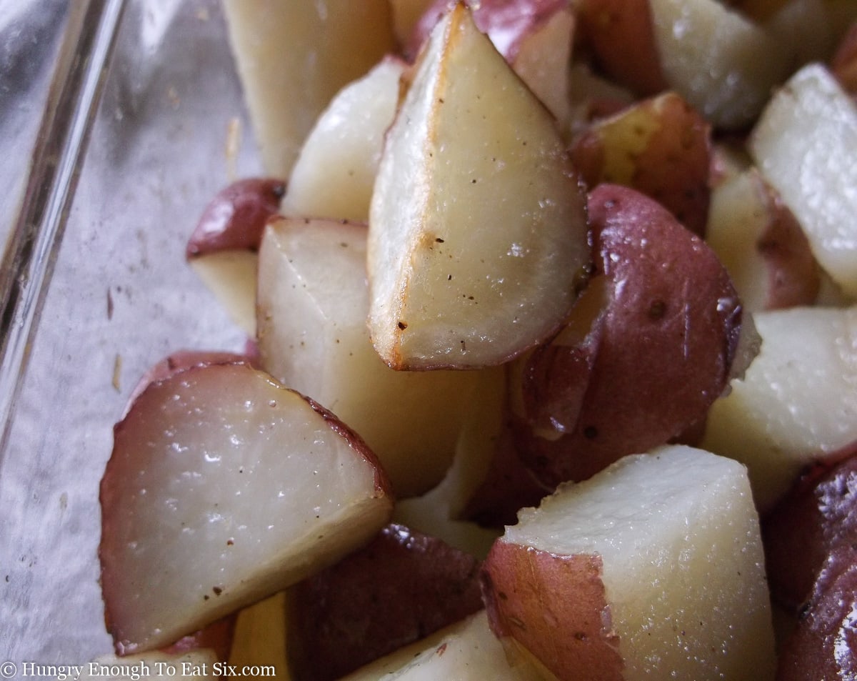 Baking dish with sliced roasted red potatoes