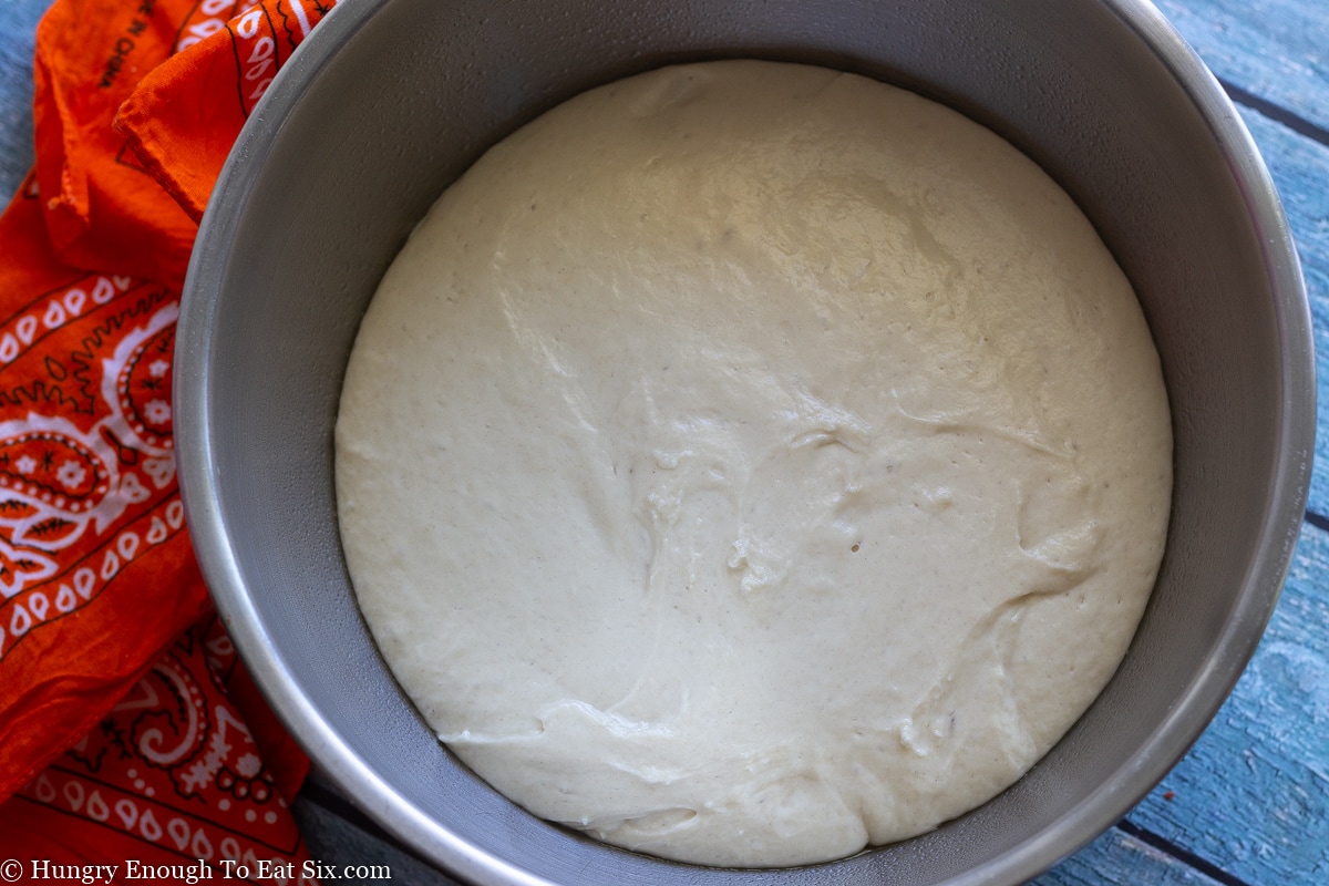Bread dough rising in a silver bowl