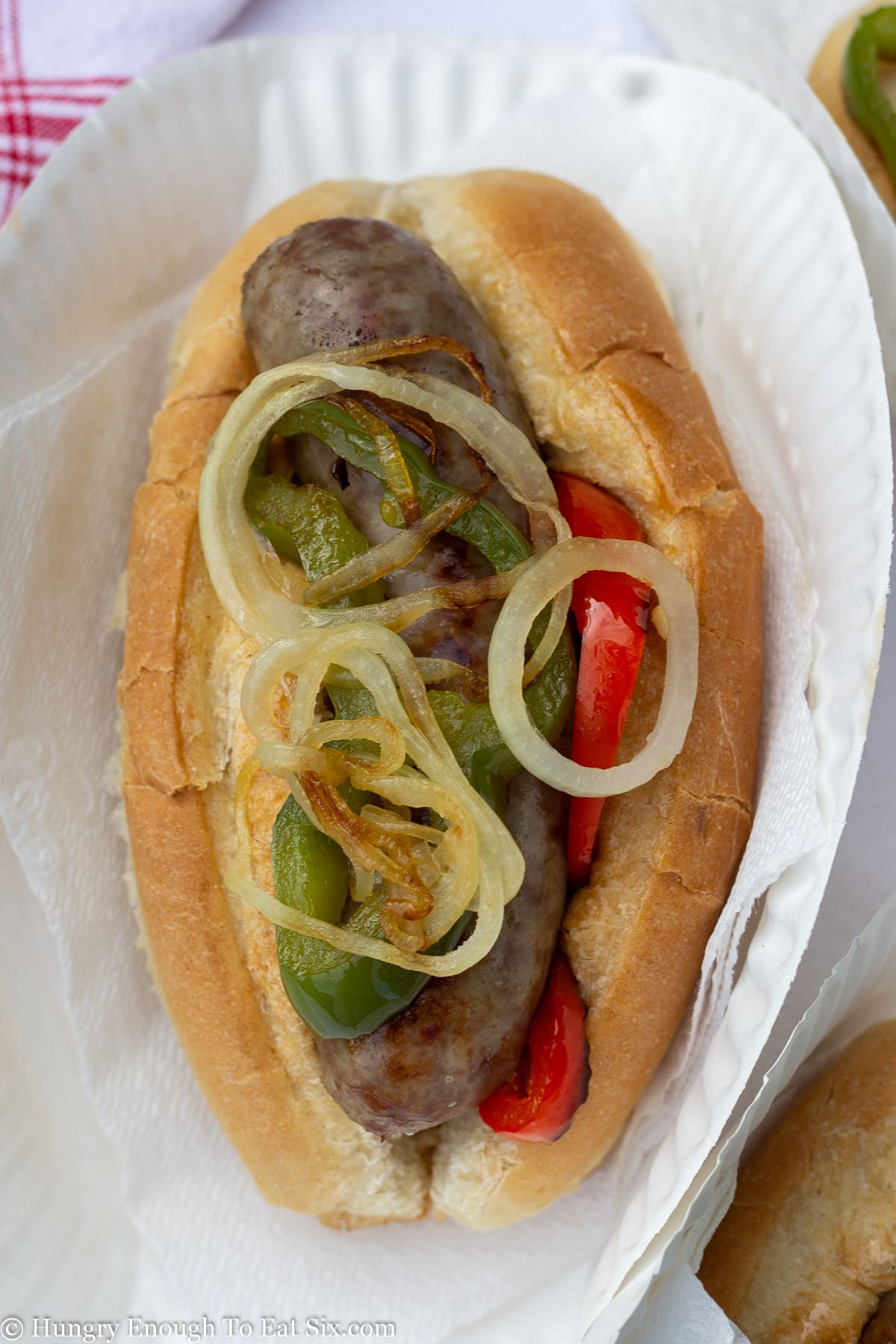 Long sub roll with sausage and sliced peppers and onions.