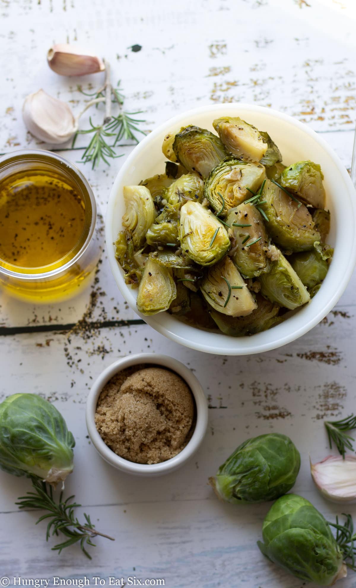 Brussels sprouts roasted in a bowl next to olive oil.