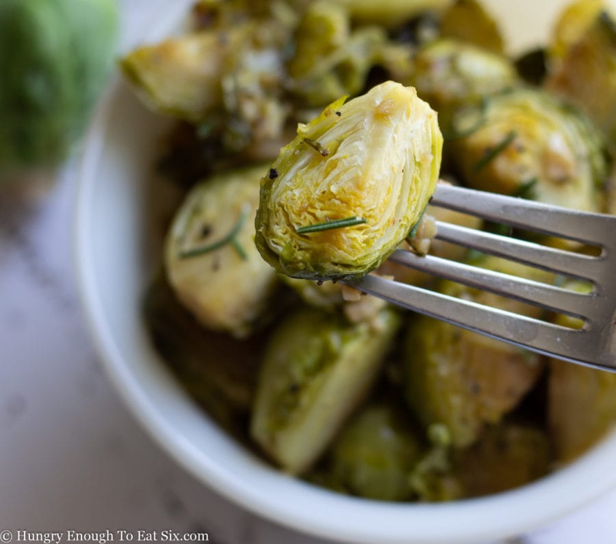 Sliced and roasted Brussels sprouts on a fork.