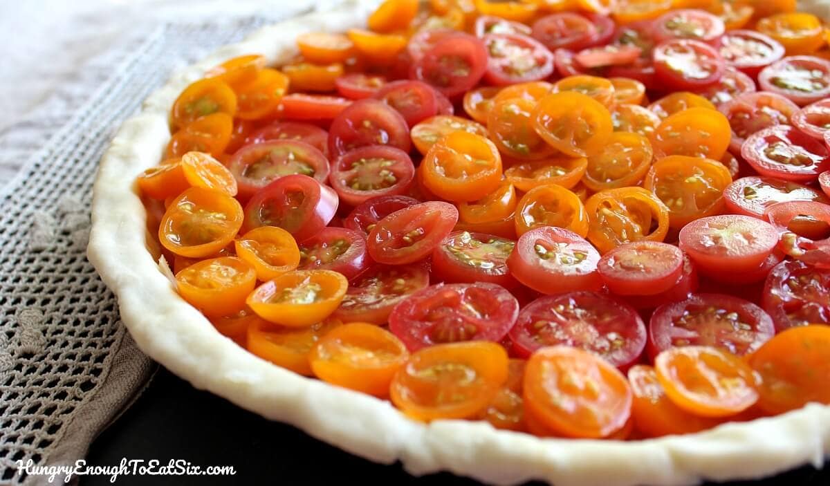 The beautiful flavors of basil and sweet tomatoes come together in this cheesy tart!