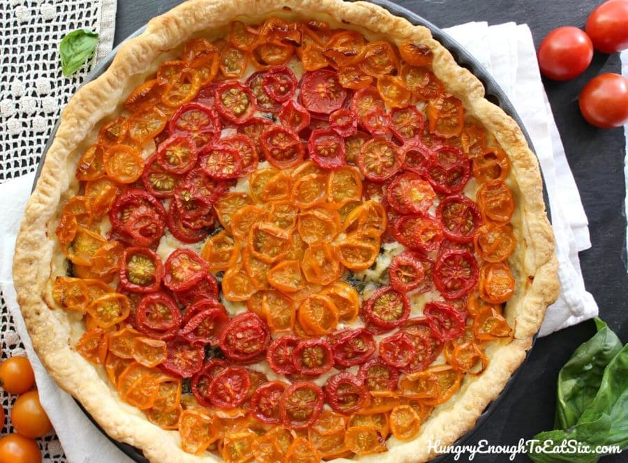 The beautiful flavors of basil and sweet tomatoes come together in this cheesy tart!