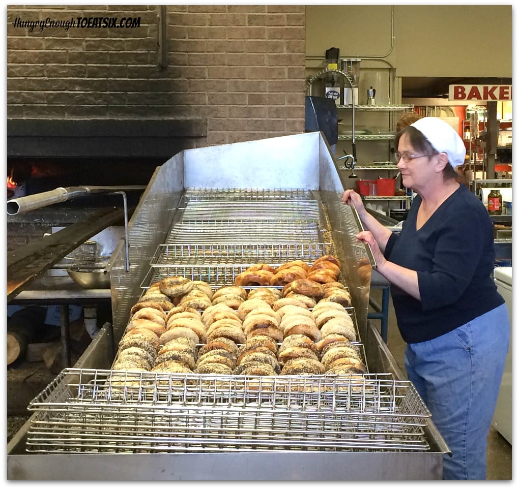Fresh bagels in racks by oven