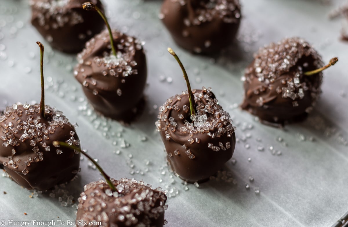 Chocolate covered cherries on wax paper.