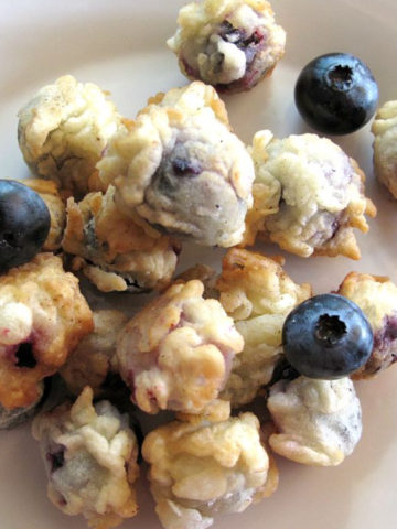 Deep fried blueberries with a few fresh blueberries