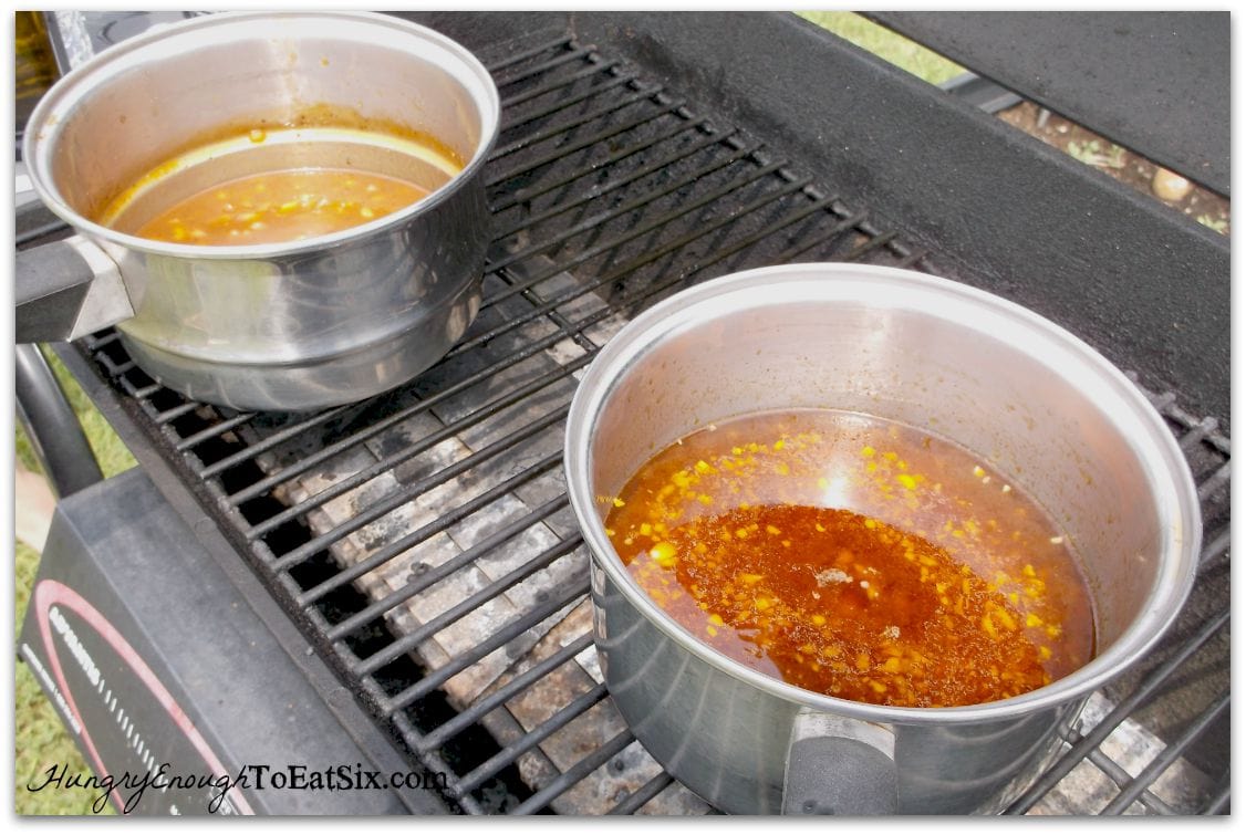 Pans of sauce on a grill