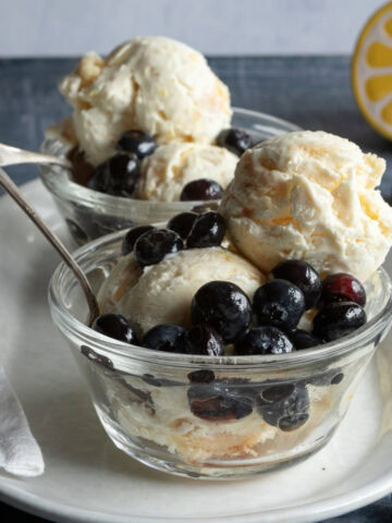 Ice cream with blueberries in glass dishes.