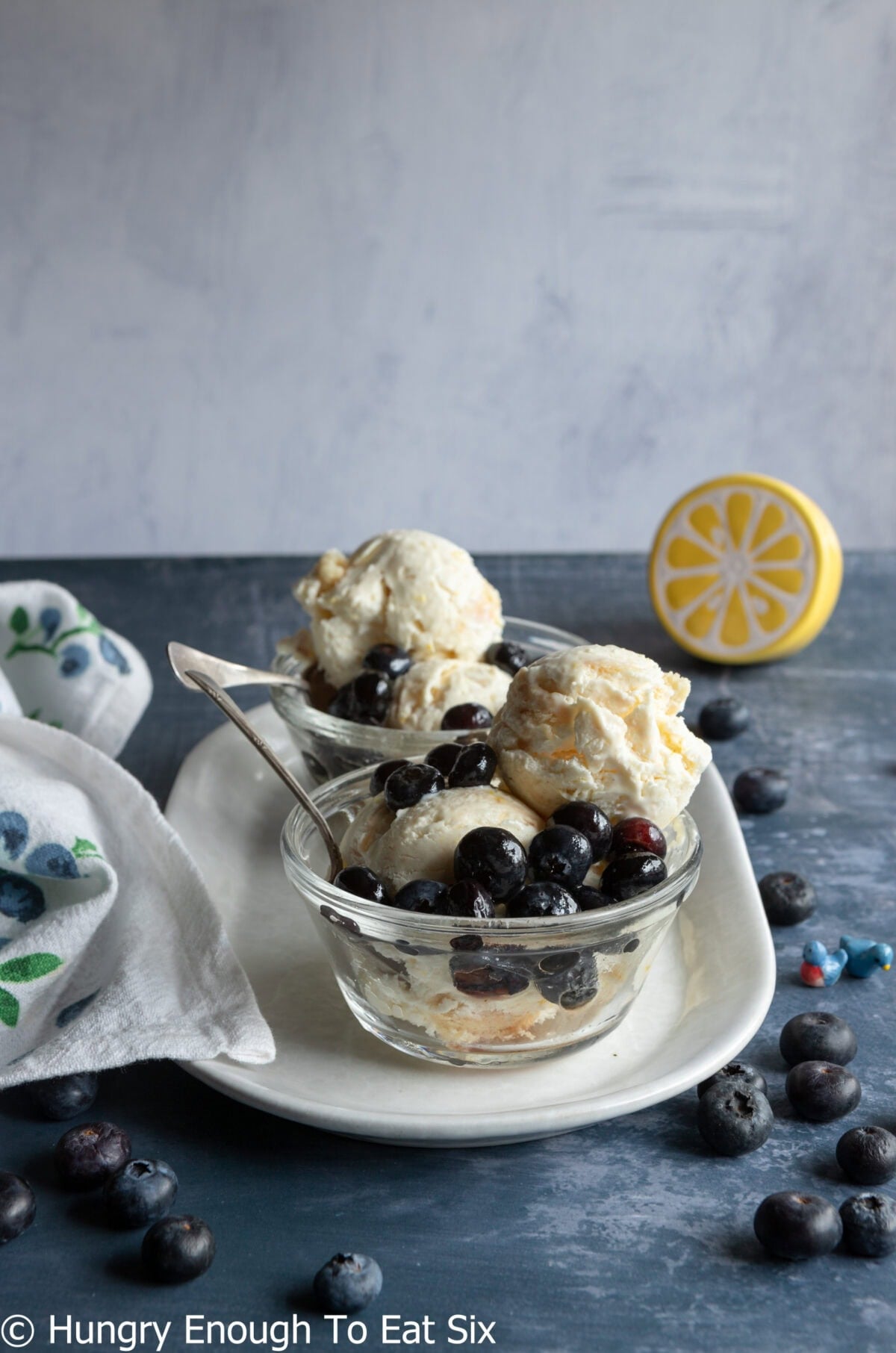 Small glass bowls with blueberries and ice cream.