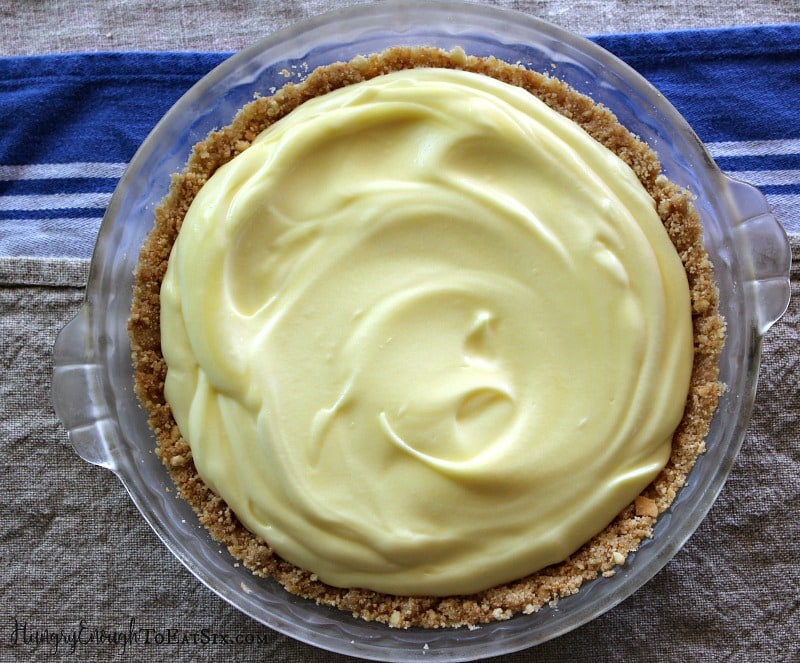 Yellow lemon pudding spooned into a vanilla cookie pie crust.