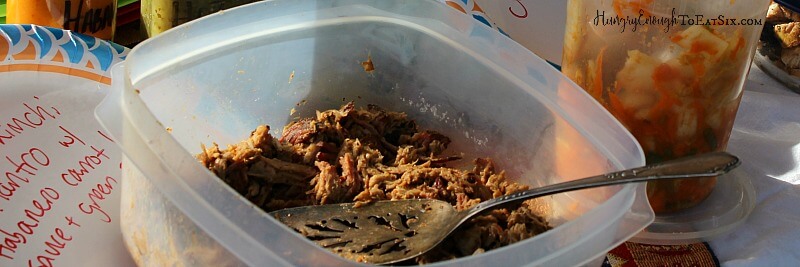 Meat filling in a plastic dish with a metal spatula.