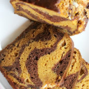Pumpkin bread with slices cut off revealing chocolate stripes