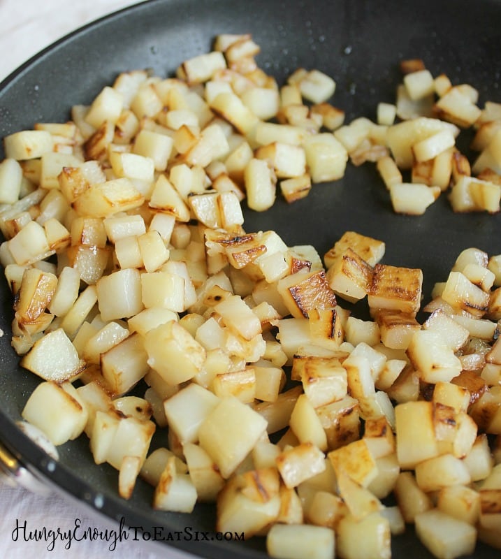 Fried diced potatoes in a nonstick pan