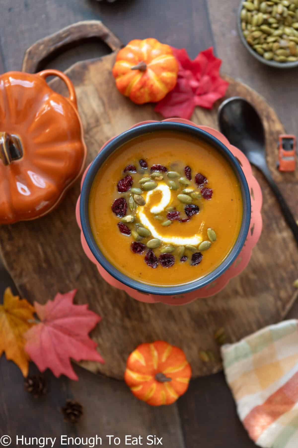Spicy pumpkin soup with an orange hue in a bowl.