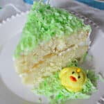Frosted slice of layer cake with yellow frosting chick.