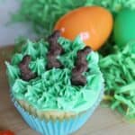 Green frosted cupcake topped with chocolate bunnies, Easter Surprise Cupcakes.