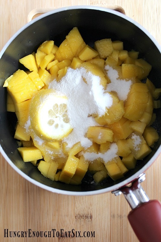 Chopped mango and sugar in a pan