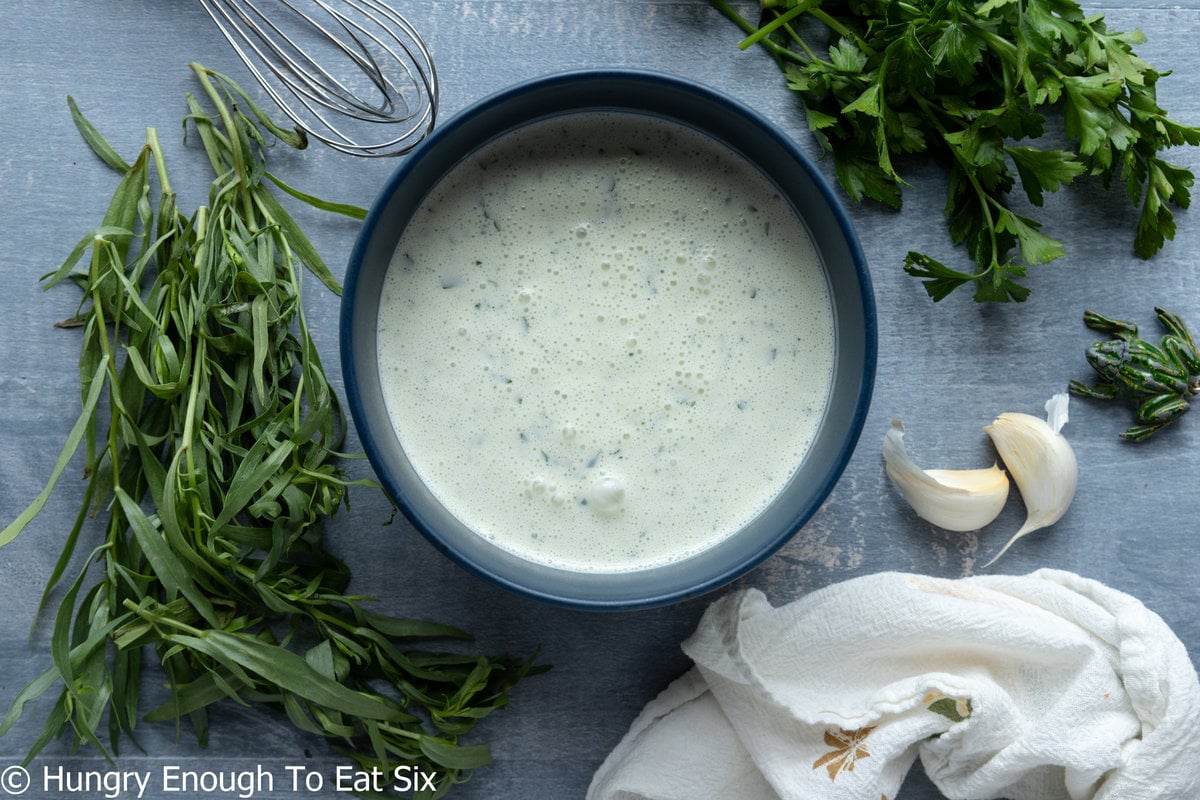 Bowl with buttermilk and herb dressing.