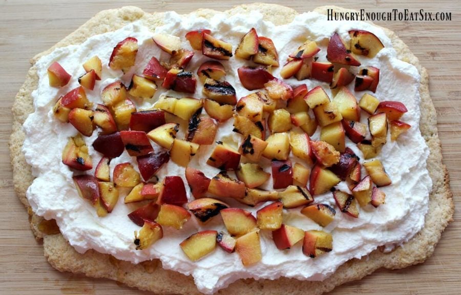 Long slab of shortcake with cream and diced peaches