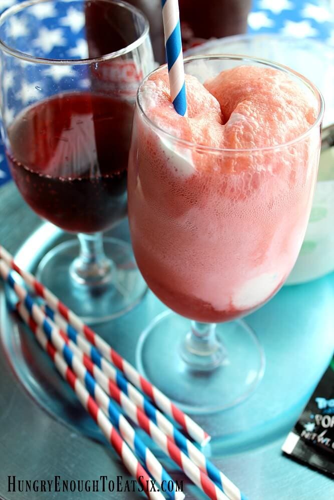 Two glasses, one with cherry soda, the other with ice cream bubbling in the soda. 