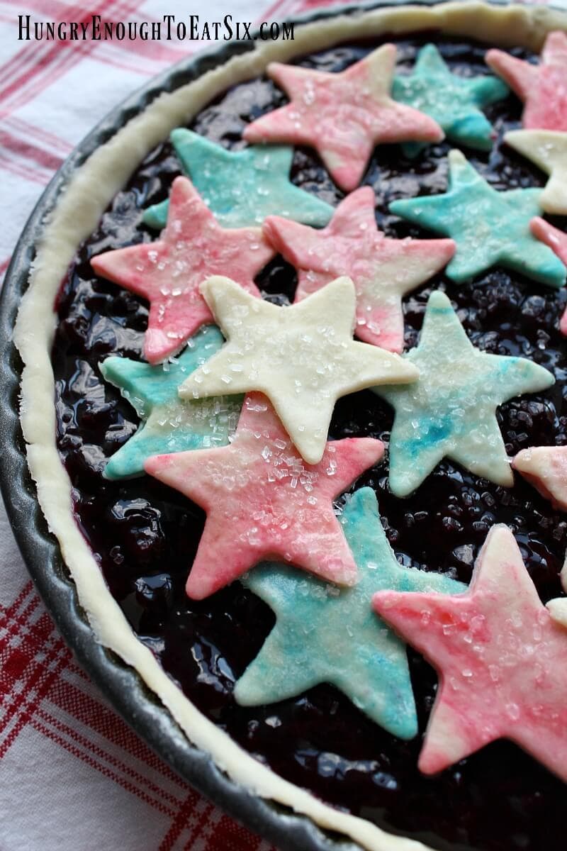 Red, white and blue pastry stars over a cherry blueberry filling in a round tart shell.