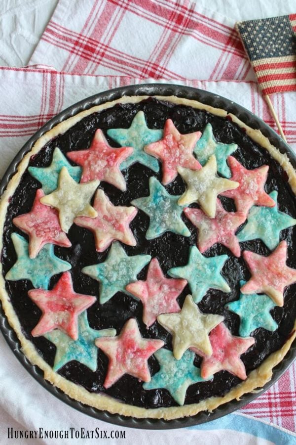A summery fruit tart with a sweet filling of cherries and blueberries! And atop the tart a few red, white and blue stars - for the 4th of July or anytime.