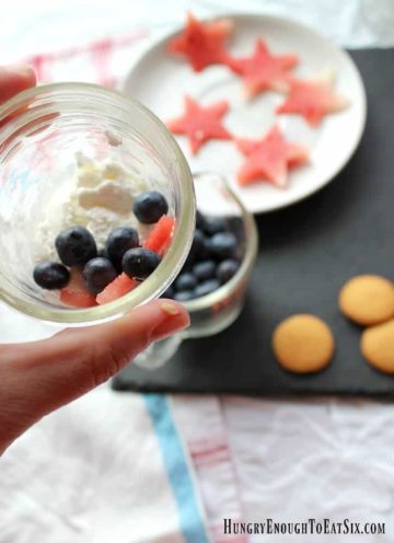 A layered fruit and cream dessert variety of fool! This fool boasts red, white and blue in the form of red watermelon stars, fresh, white whipped cream and juicy blue blueberries. Topped with a cookie. A sweet, vanilla, crunchy cookie to complete this fruity fool.