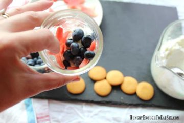 A layered fruit and cream dessert variety of fool! This fool boasts red, white and blue in the form of red watermelon stars, fresh, white whipped cream and juicy blue blueberries. Topped with a cookie. A sweet, vanilla, crunchy cookie to complete this fruity fool.