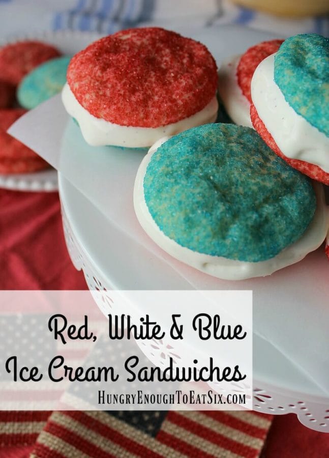 Red, white and blue ice cream sandwich cookies on a white pedestal.
