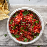 Salsa with basil leaves in bowl