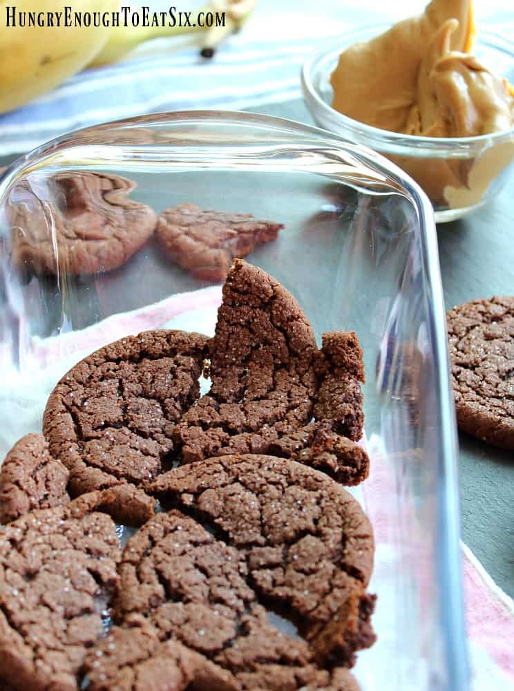 Broken chocolate cookies in a glass baking pan.