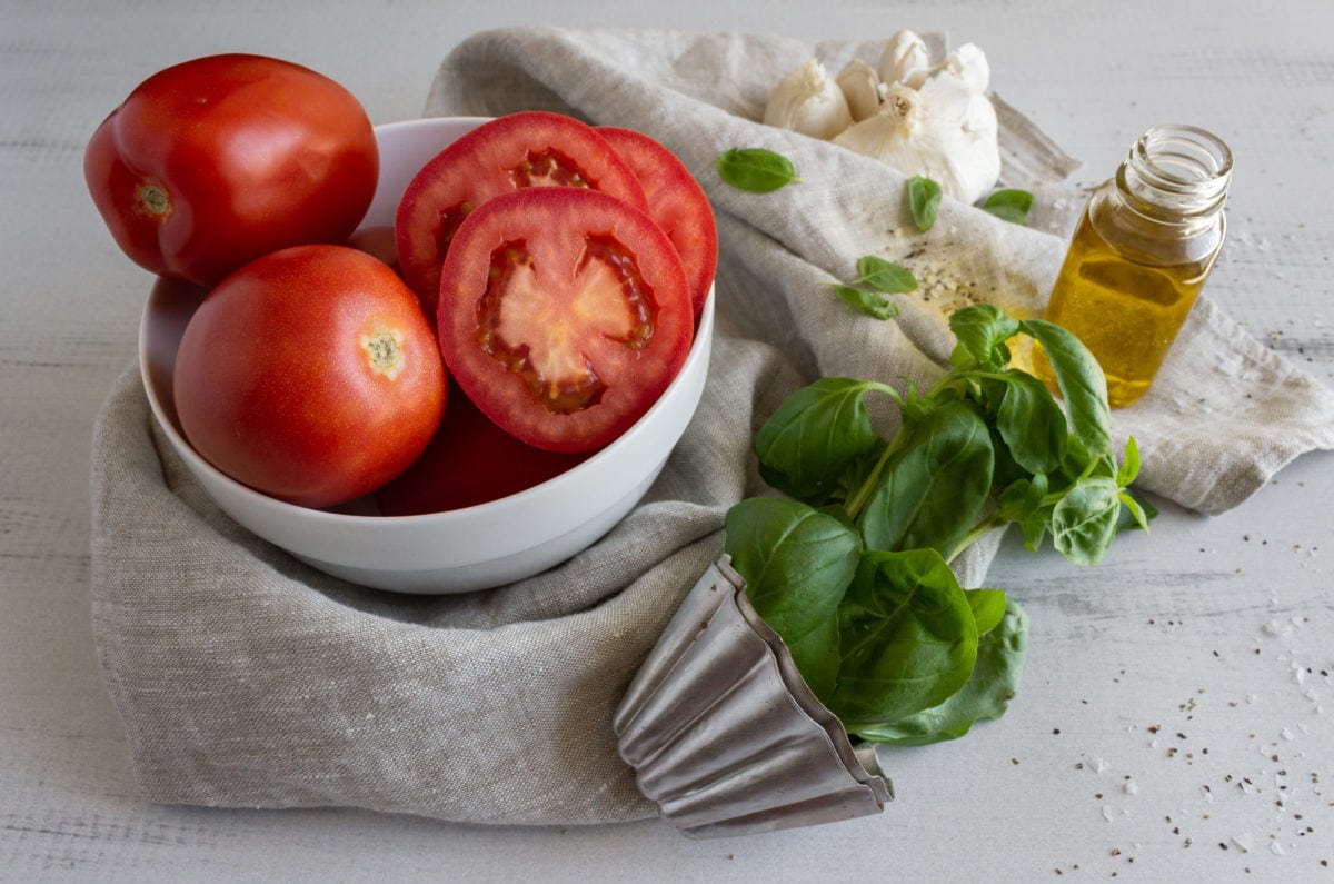 Tomatoes, basil leaves, and garlic