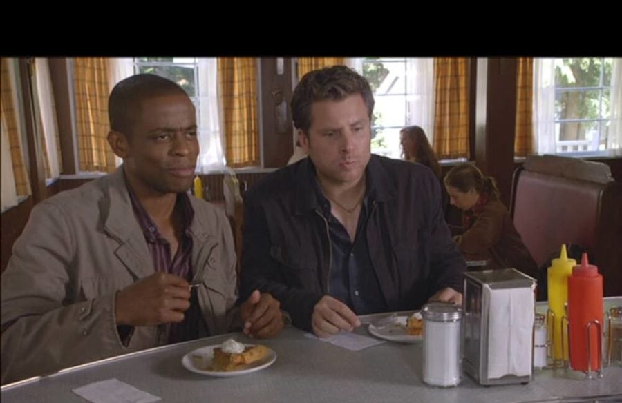 Still from Psych tv show with two men eating pie at a counter.