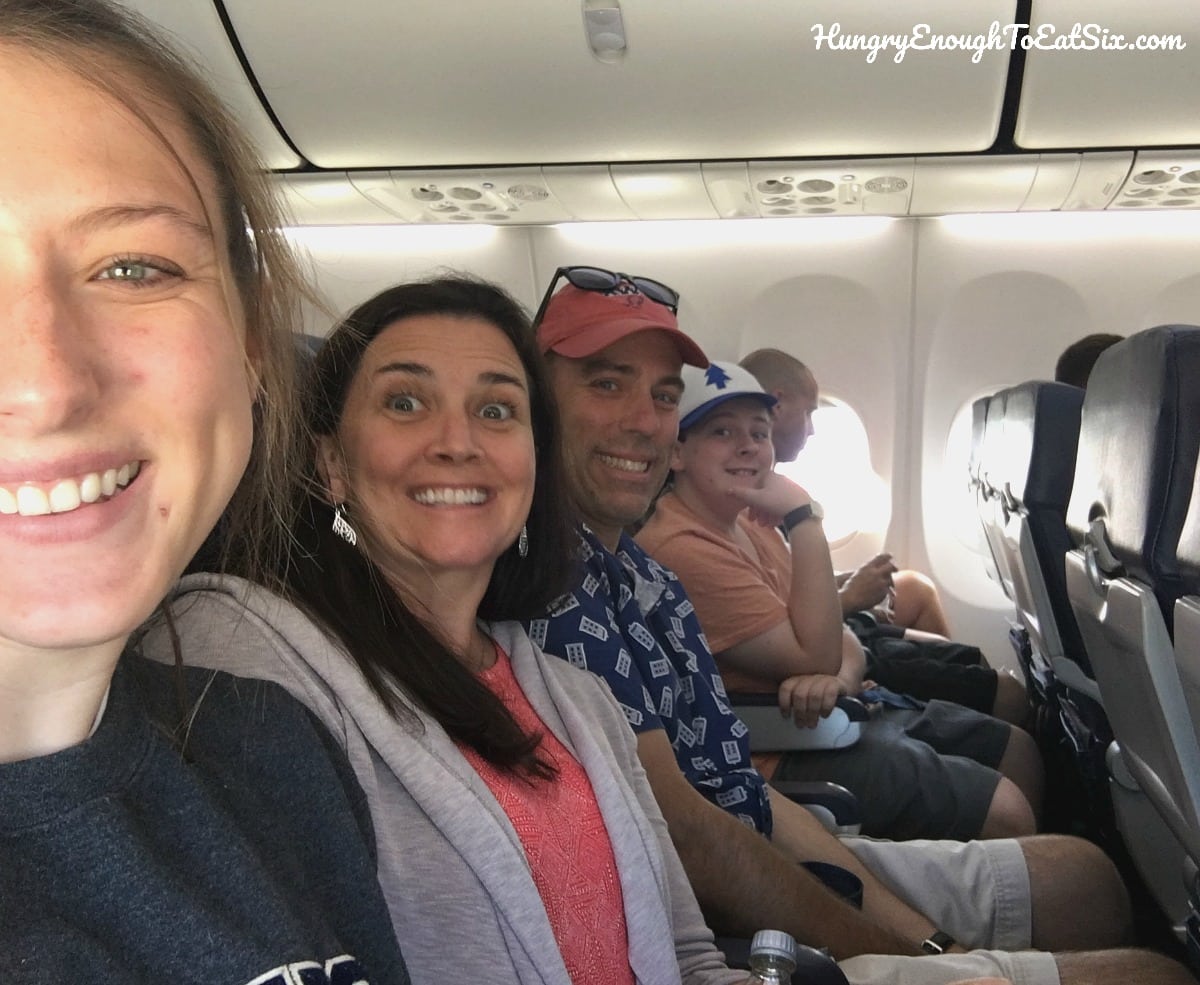 Parents and teen kids on an airplane