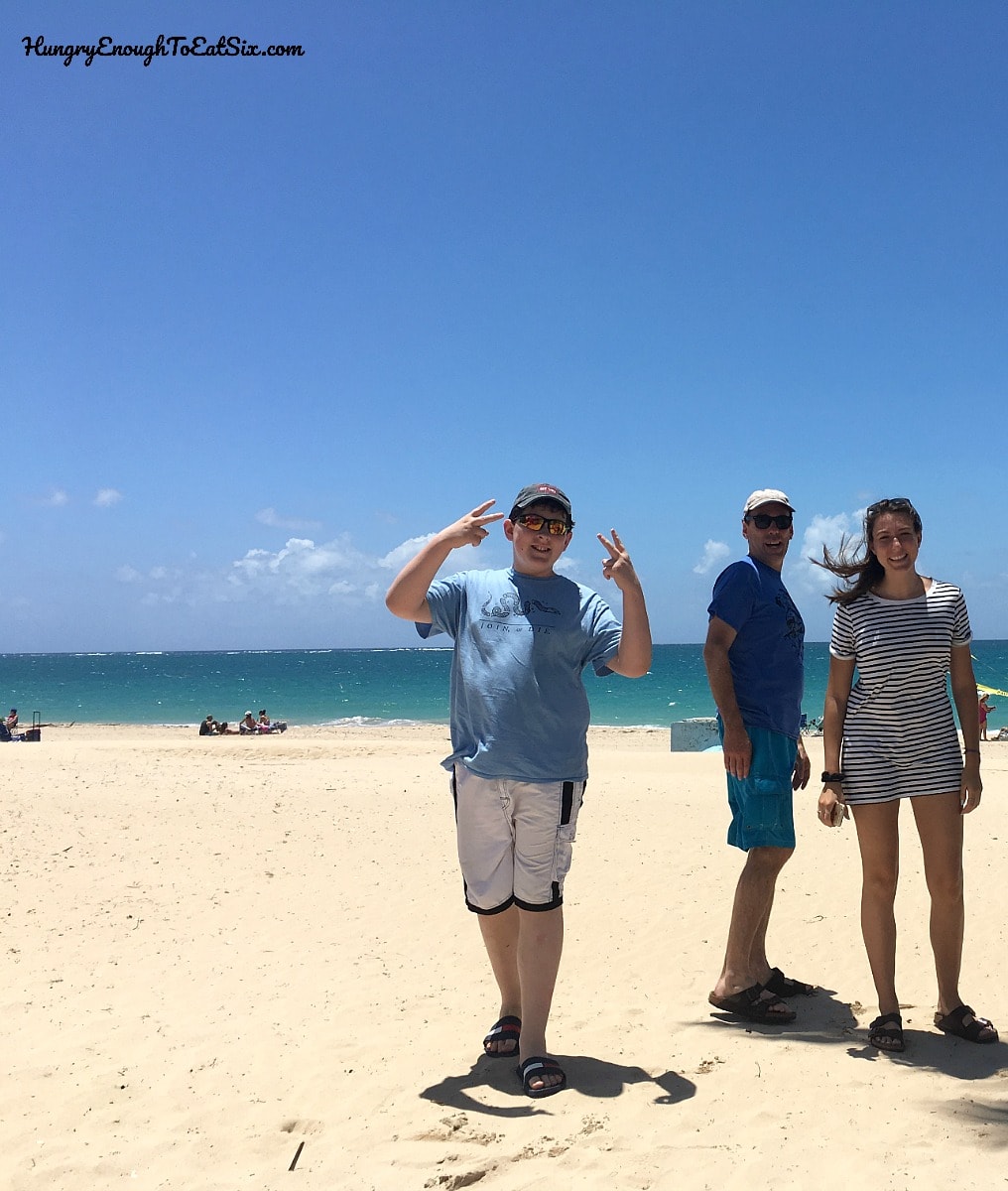 Man and two teens on a tropical beach
