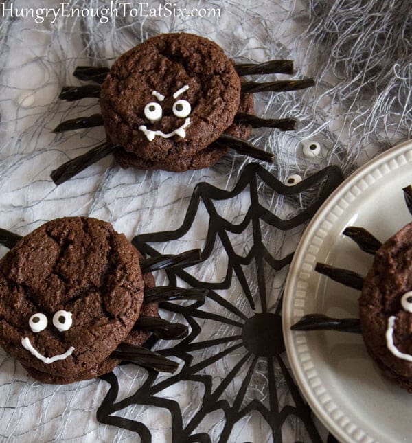 Sandwiched chocolate cookies with black licorice and candy eyeballs