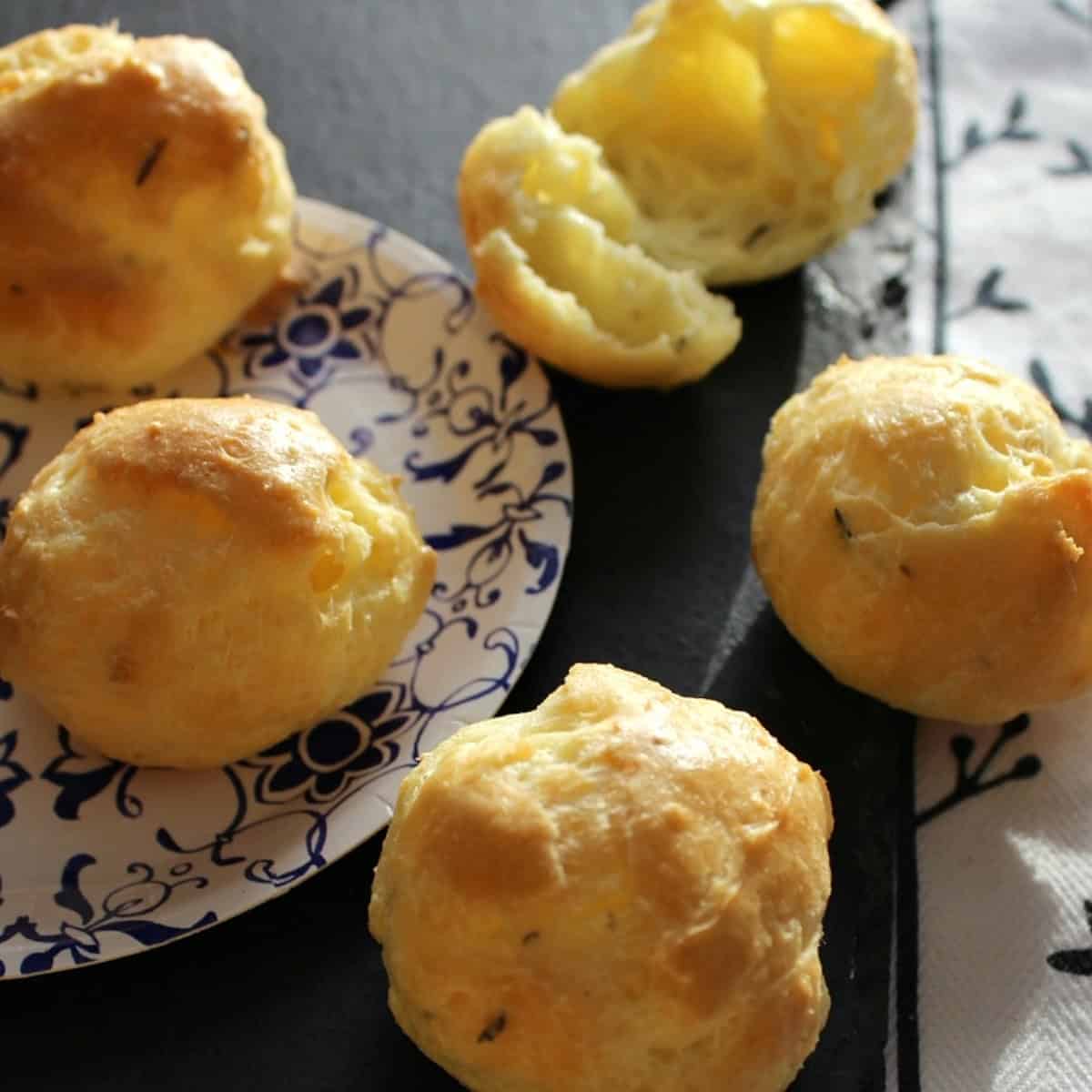 Herbed pastry puffs on a paper plate.