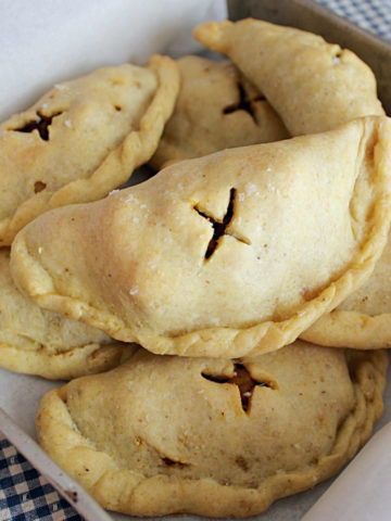 Baked empanadas with an x in the top