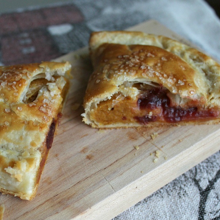 A Pumpkin Cranberry hand pie cut in half to show the filling.