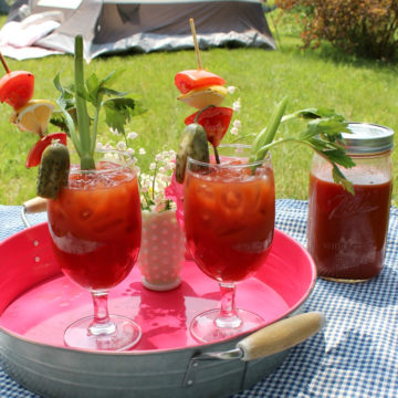 Garnished Bloody mary drinks on a metal tray