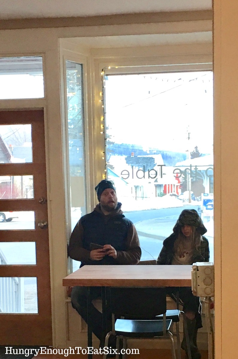 Man and boy sitting by a window