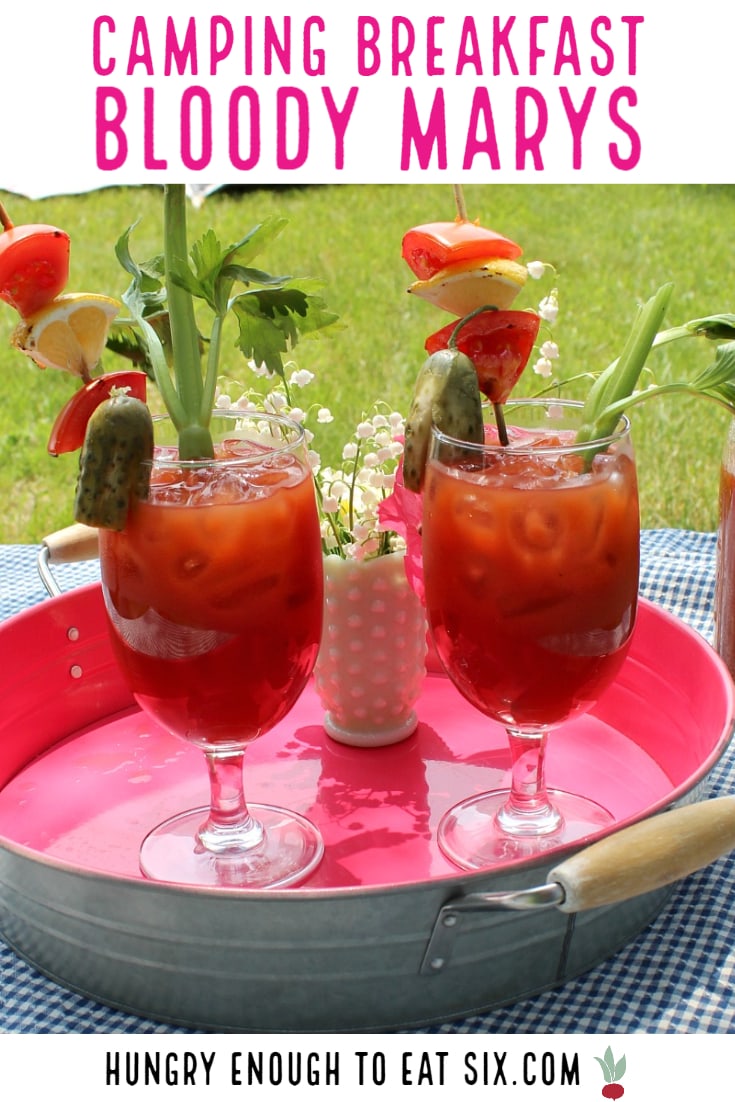 Pink tray with two glasses of Bloody Mary drinks.