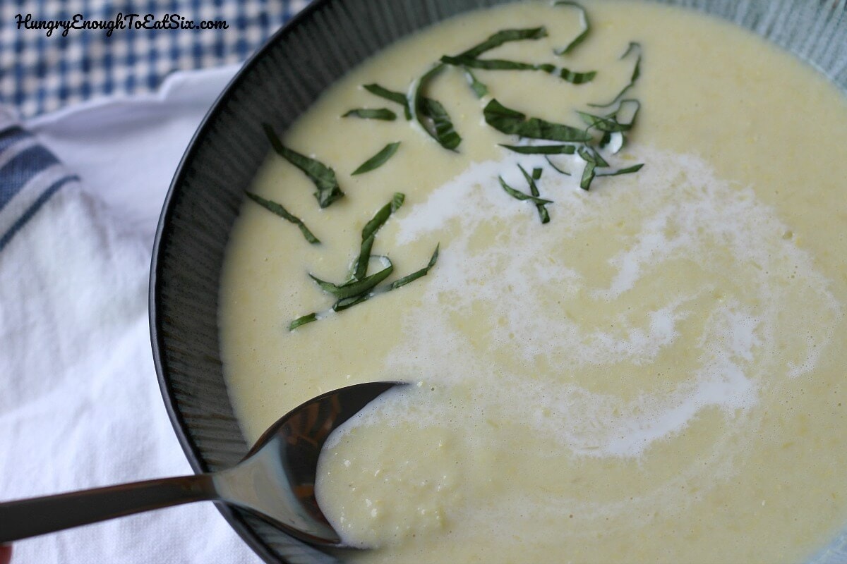 Image of Chilled Sweet Corn Soup in a bowl with fresh herbs on top