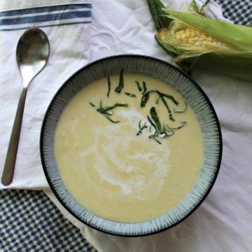 Image of Chilled Sweet Corn Soup in a bowl with fresh herbs on top