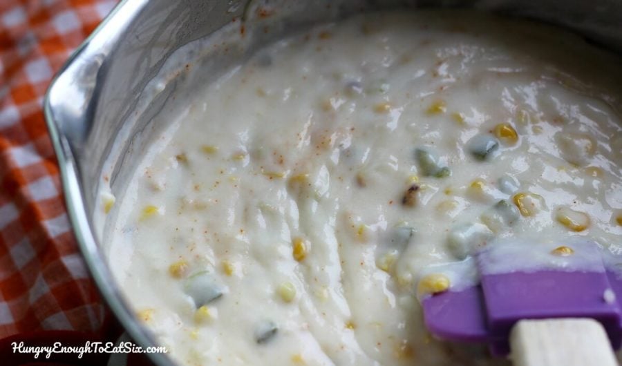 Pan of melting queso dip with corn.