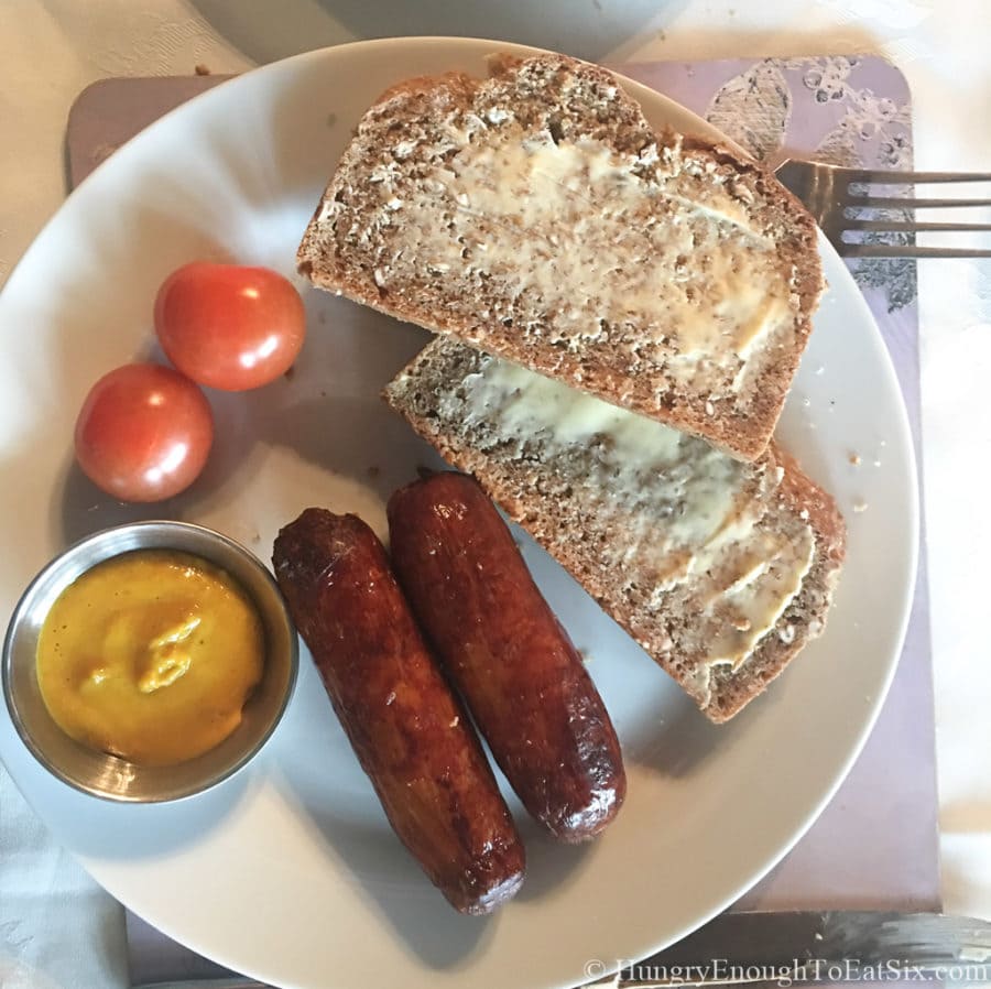 Image of breakfast at Rossmore Manor: sausages, brown bread with mustard