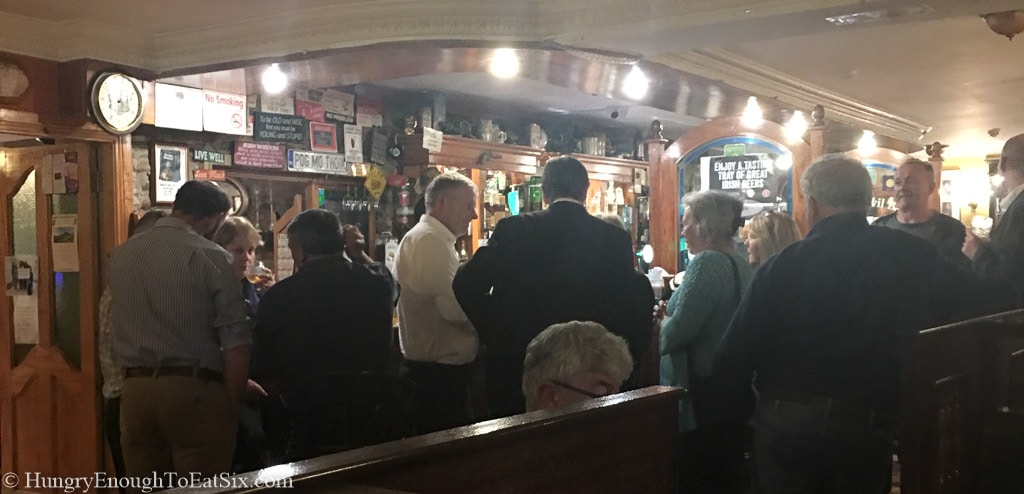 Inside the Anvil Bar in Castlemaine Ireland, people gathered at the bar.