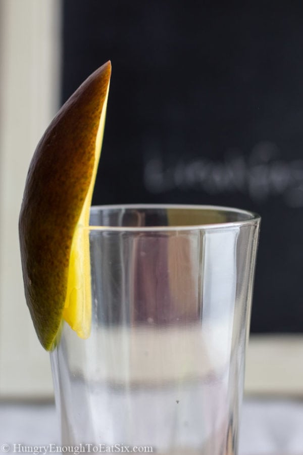 Image of a mango on the rim of a glass